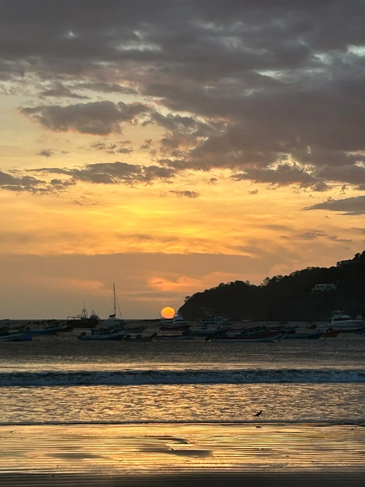 Sunset over the bay with fishing boats in San Juan del Sur, Nicaragua